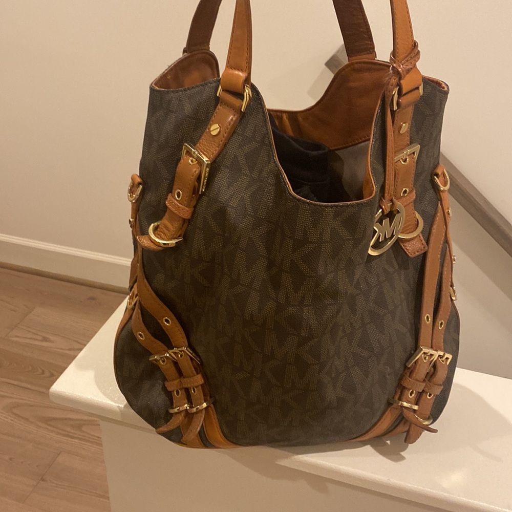 Authentic michael Kors bag with buckles.